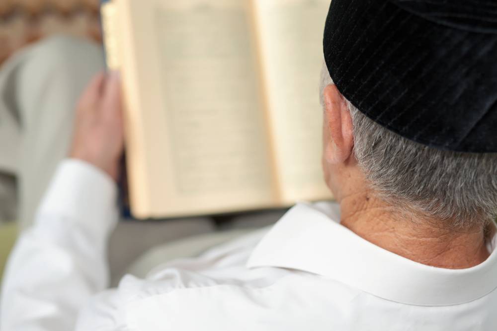 An old man reading a book. Selective focus